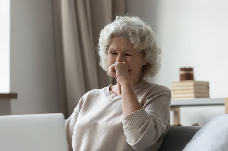 Upset senior on a laptop