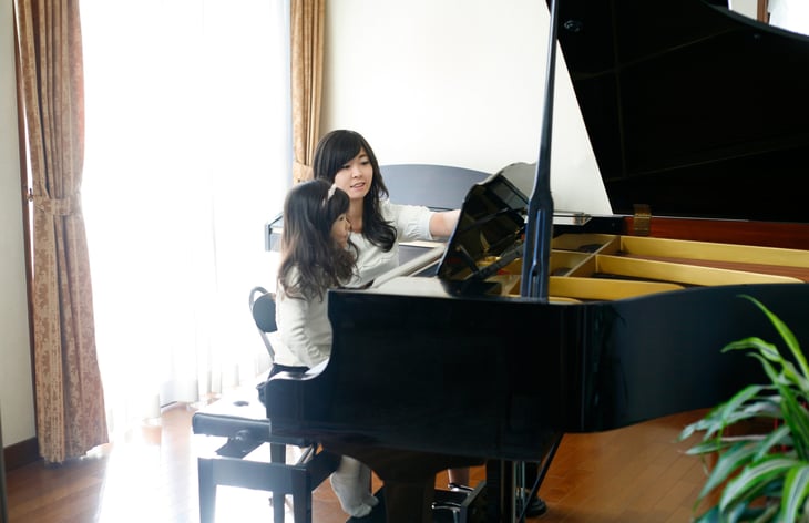 Woman teaching piano lessons