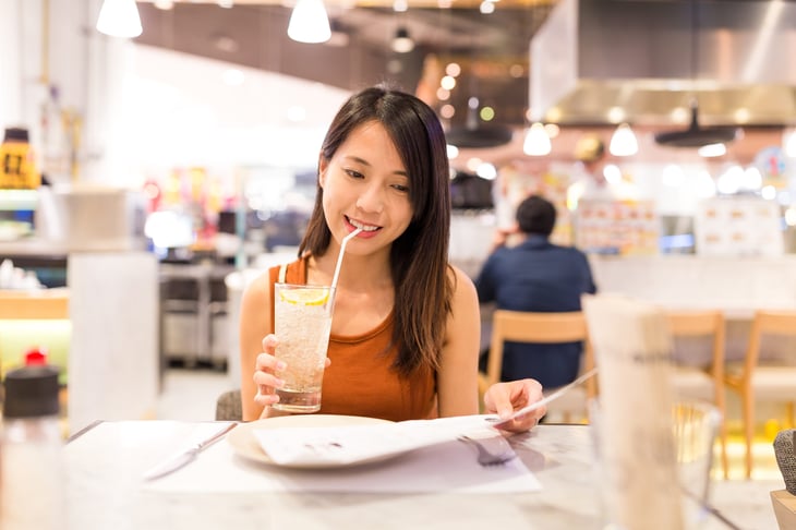 Woman drinking a beverage in a restaurant