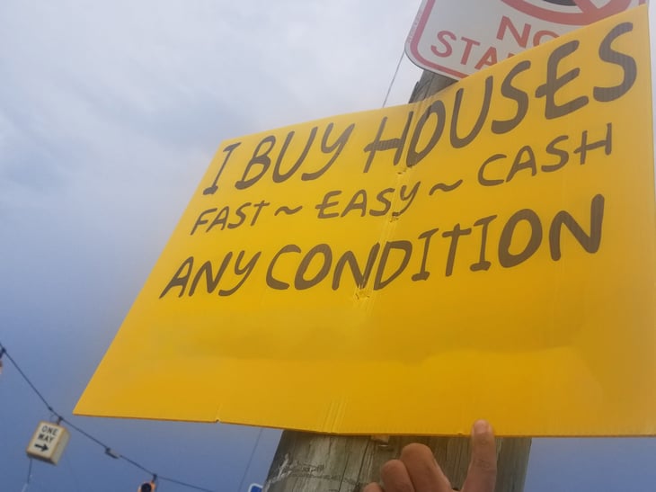 Sign offering to buy houses for cash fast