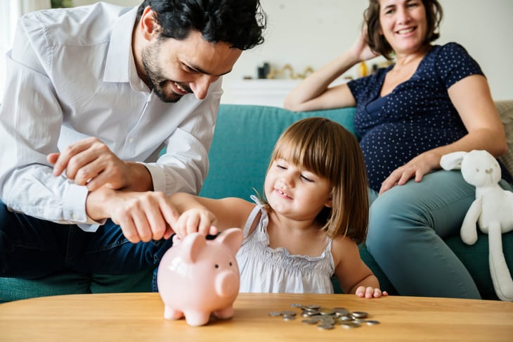 Family saving money with a piggy bank