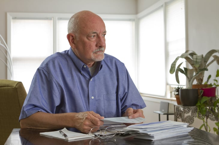 Worried senior paying bills
