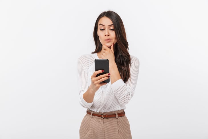 Woman thinking about her phone or a new phone plan