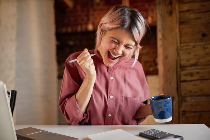 Excited woman working on taxes