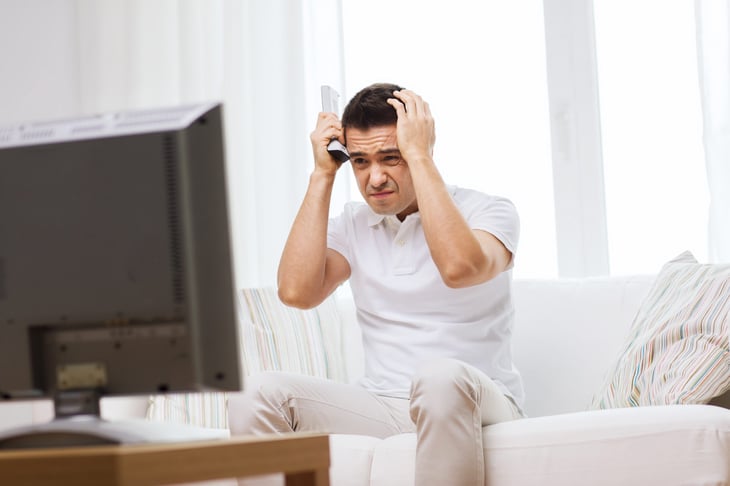 Unhappy man watching TV