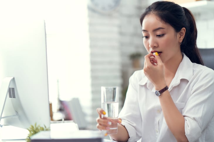 Woman taking a pill