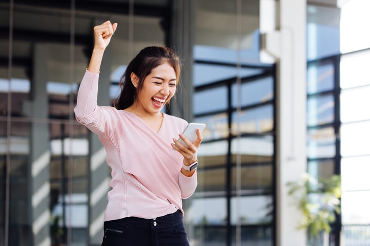 Excited woman with cellphone
