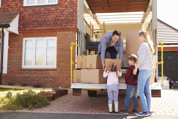 Millennial family packing moving truck