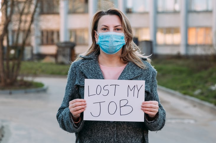 unemployed woman in mask with sign