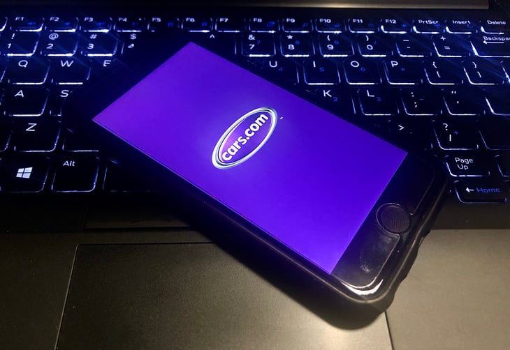 Cars.com app is open on a smartphone. Cars.com is an automotive classified website