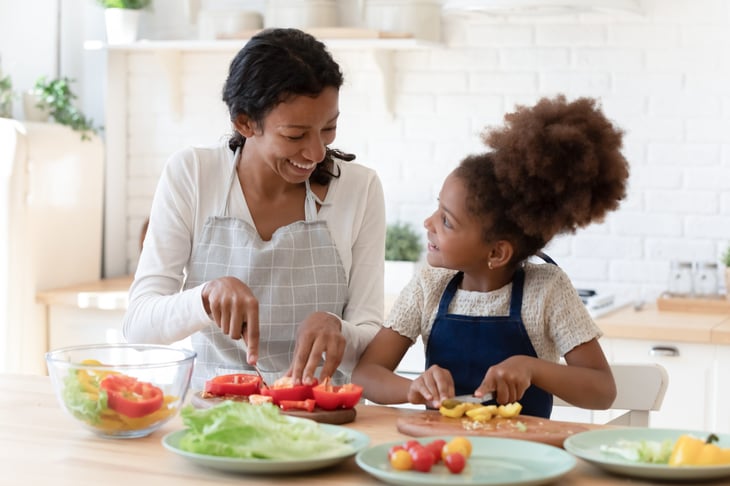 Mother and daughter making dinner at home
