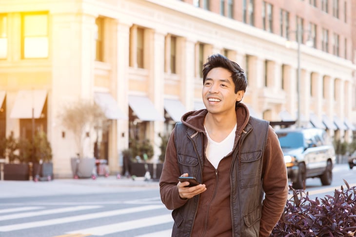Man using phone to schedule Lyft ride