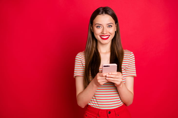 Young woman excited by her new phone