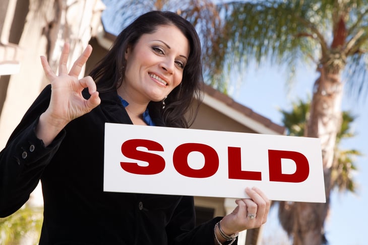 realtor with sold sign