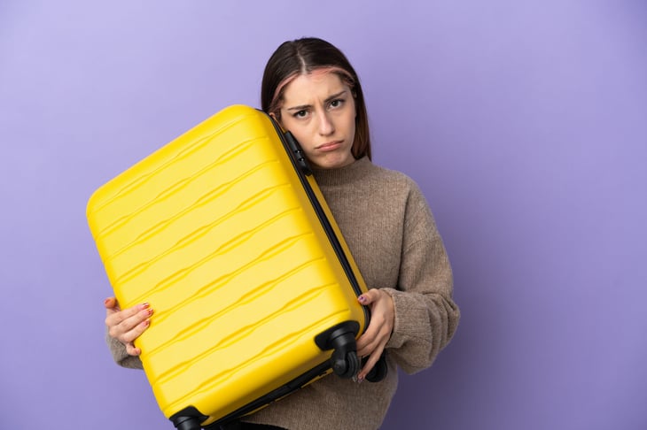 Unhappy woman with luggage