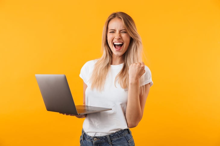 Excited woman on a laptop