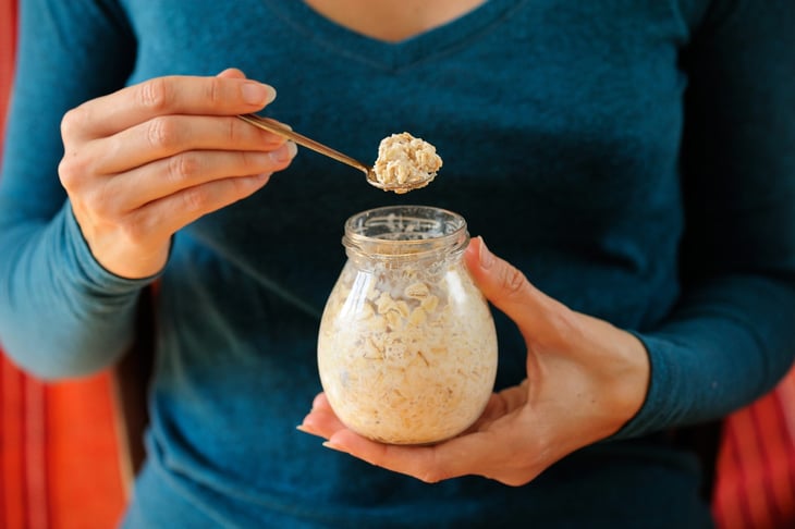 Woman eating overnight oats