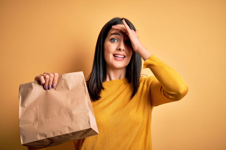 Upset woman with paper bag