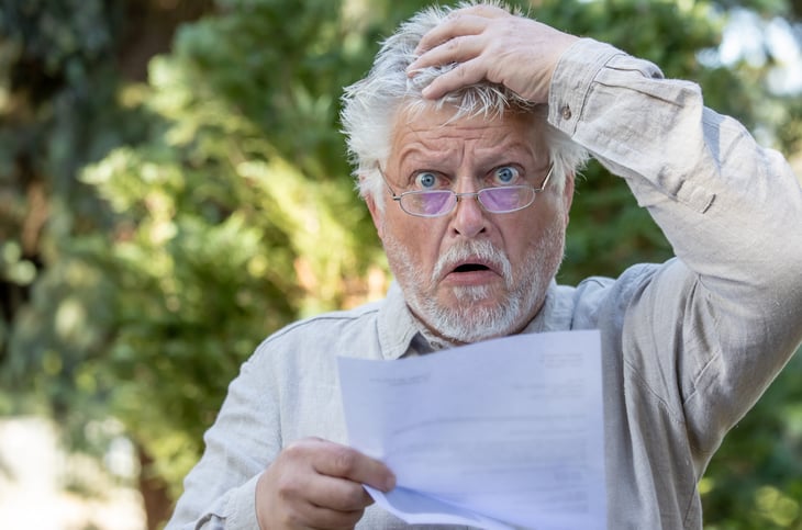 Shocked man reading letter
