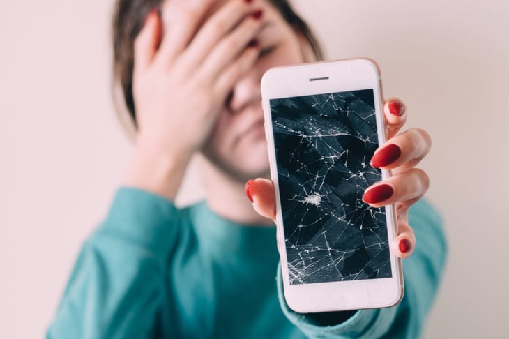 Woman with broken cell phone