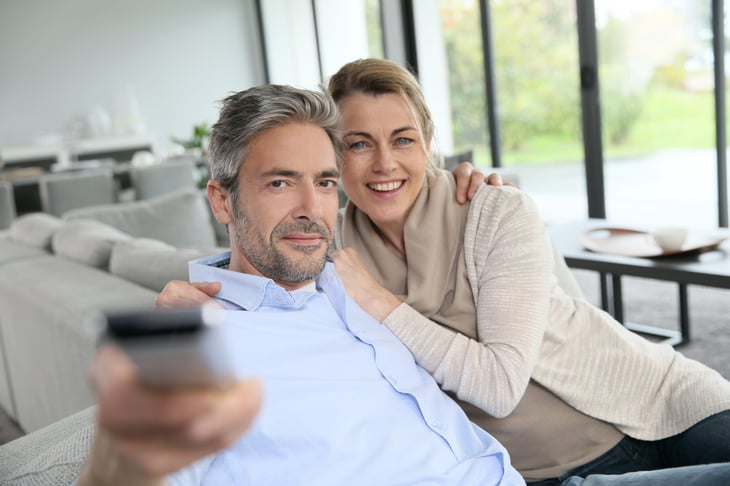 Middle-aged couple watching TV