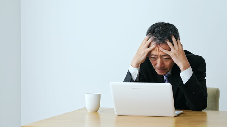 confused senior looking at computer