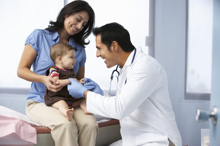 Doctor with mother and baby