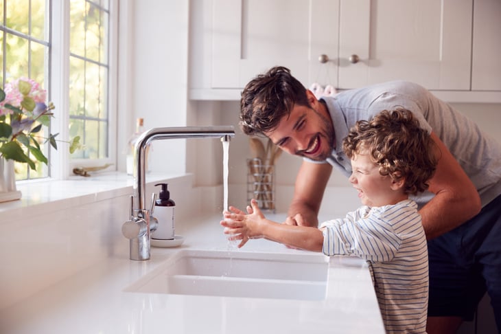 Father and child washing their hands