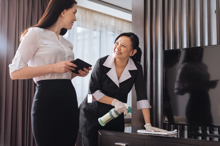 Woman talking to hotel maid
