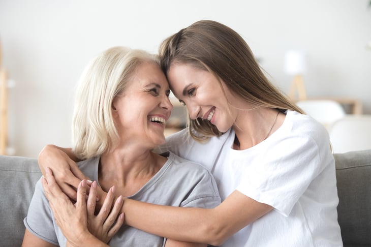 Older woman hugging her adult daughter