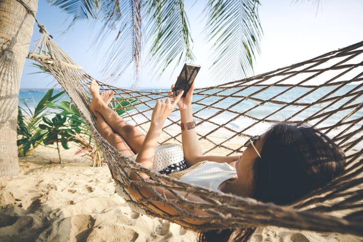 Woman at the beach on vacation with her phone