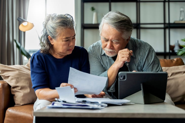 Worried seniors checking bills
