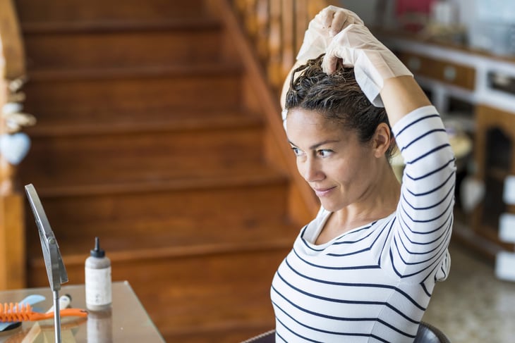 Woman dying her hair at home