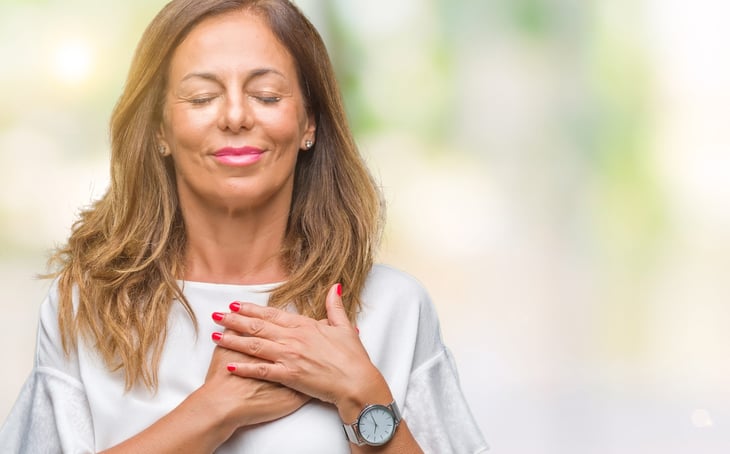 Woman with hands on her heart