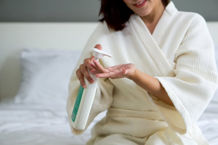 Woman using lotion