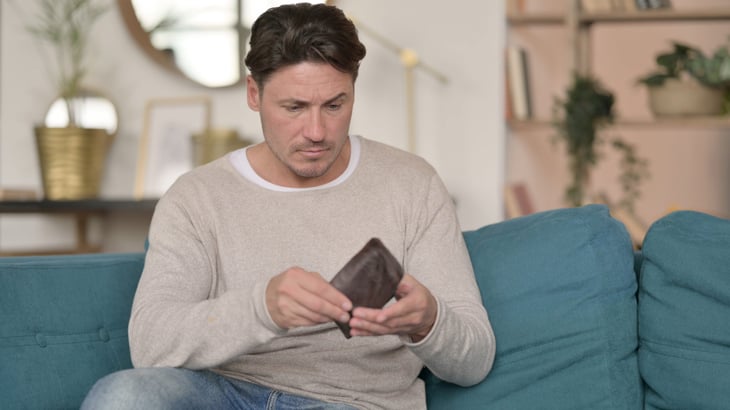 Middle-aged man with empty wallet