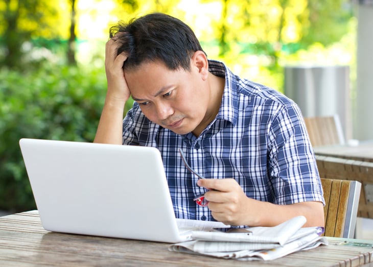 Man pondering stock trade