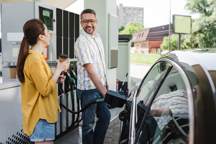 Couple buying gas and a drink