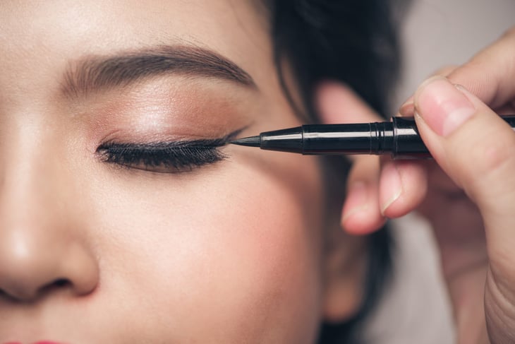Woman applying eyeliner