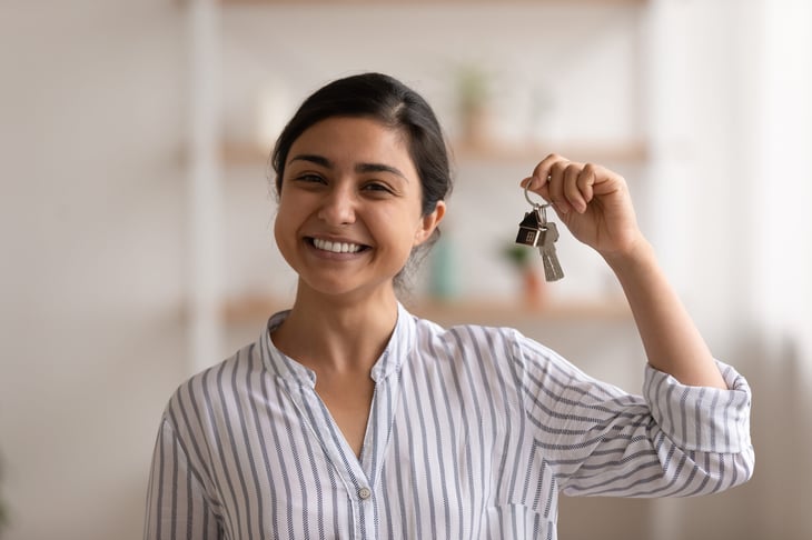 Happy homeowner holding keys