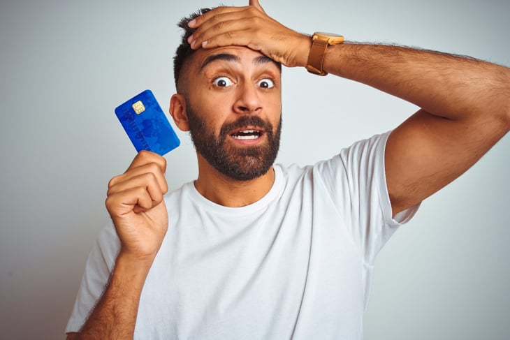 Confused man with credit card