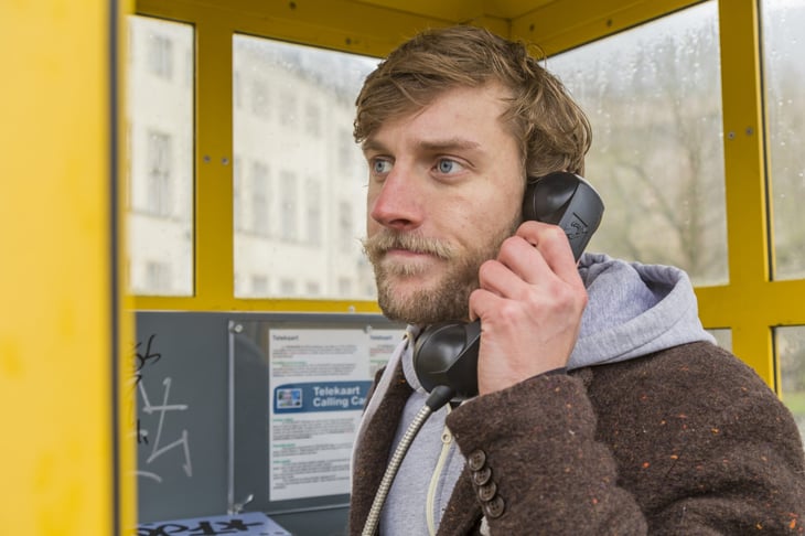 Man on a pay phone