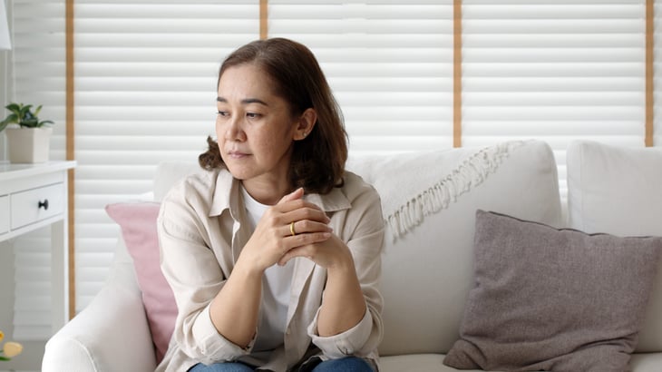 Worried woman on her sofa