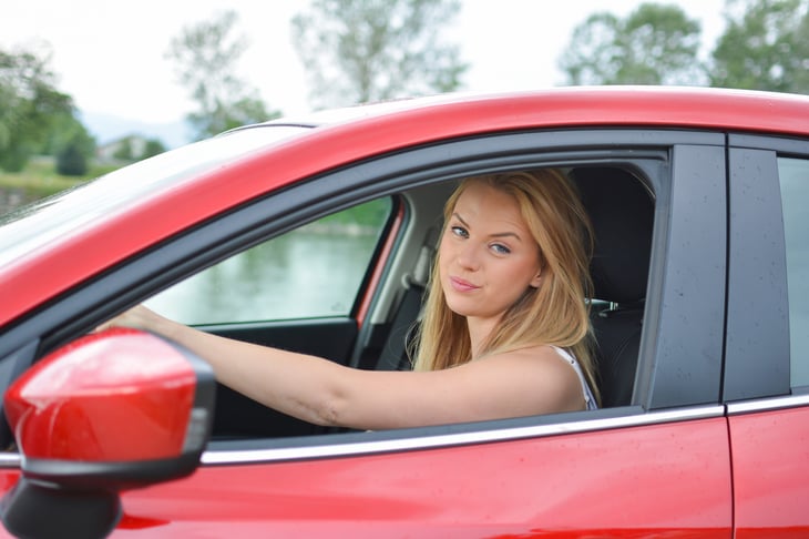 Woman frowning in her car