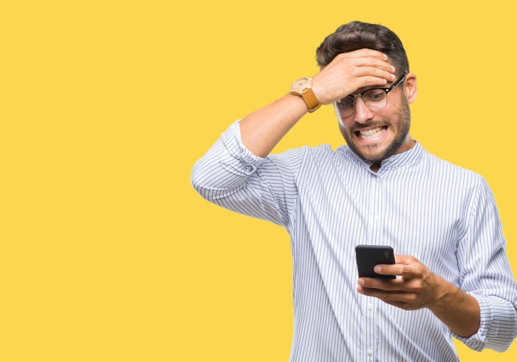Man freaking out about his phone bill and worried or upset