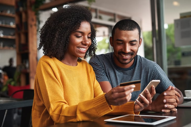 Couple in a cafe with a credit card
