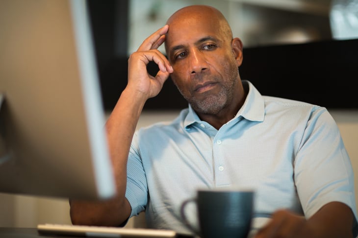 Man worrying at his computer desk