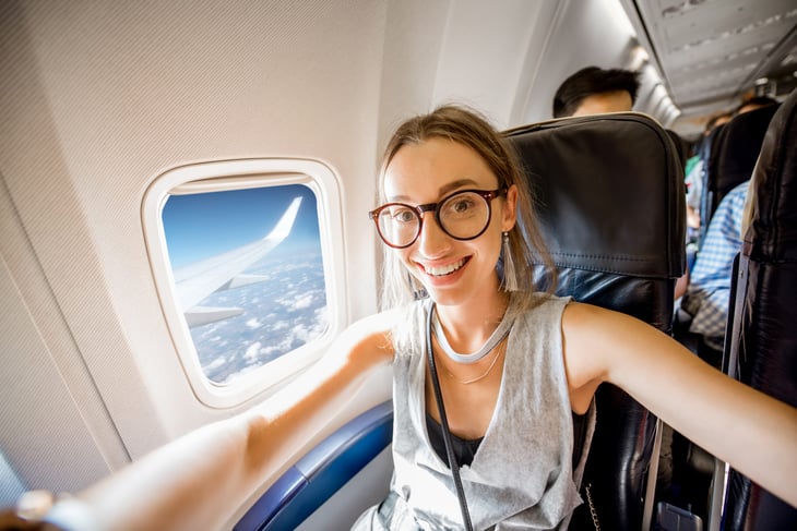 Happy woman on airplane