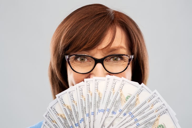 Woman holding a handful of cash