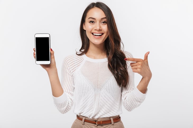 Woman pointing at her cellphone